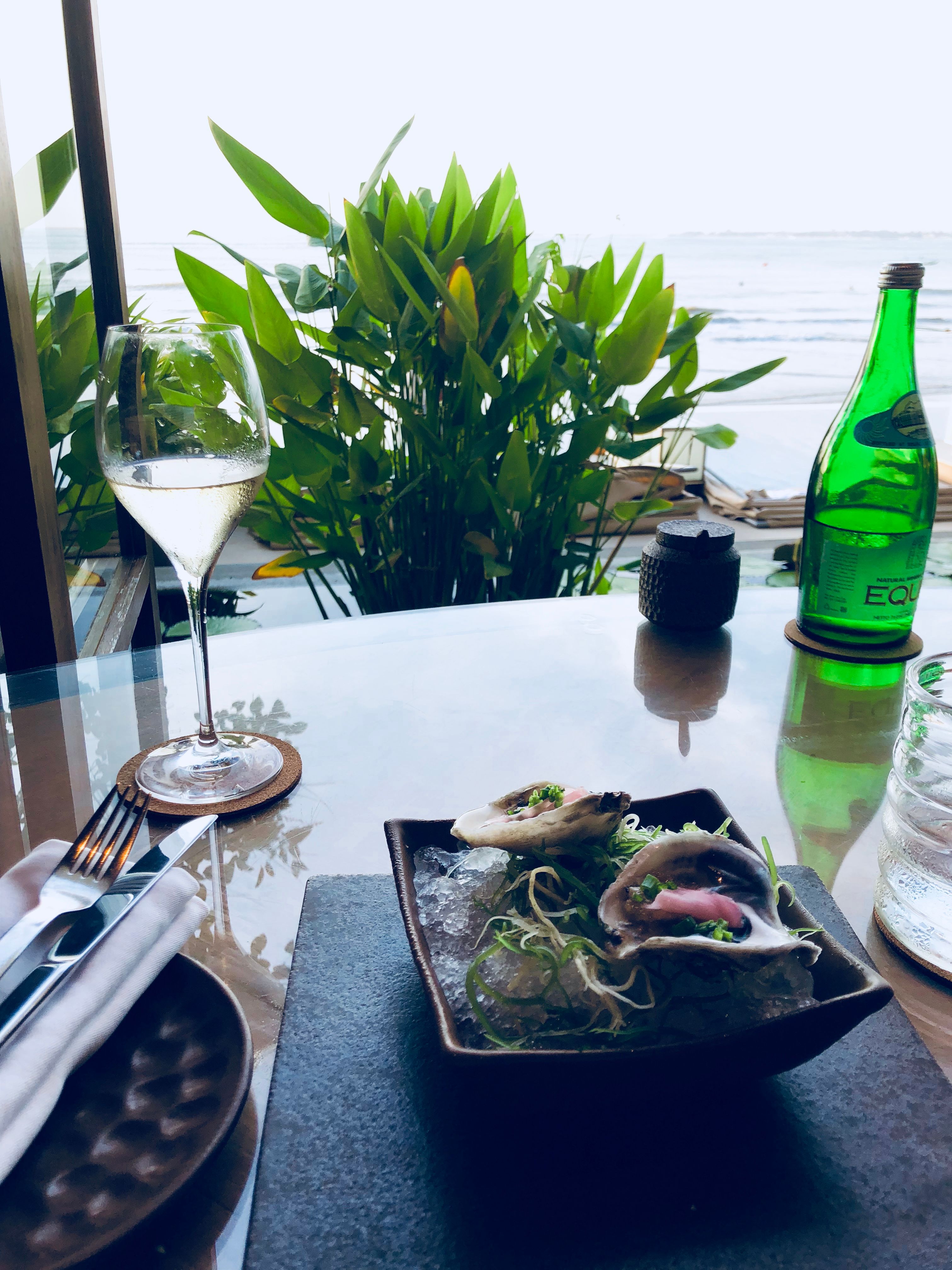 Fine dining table set beside an ocean view window