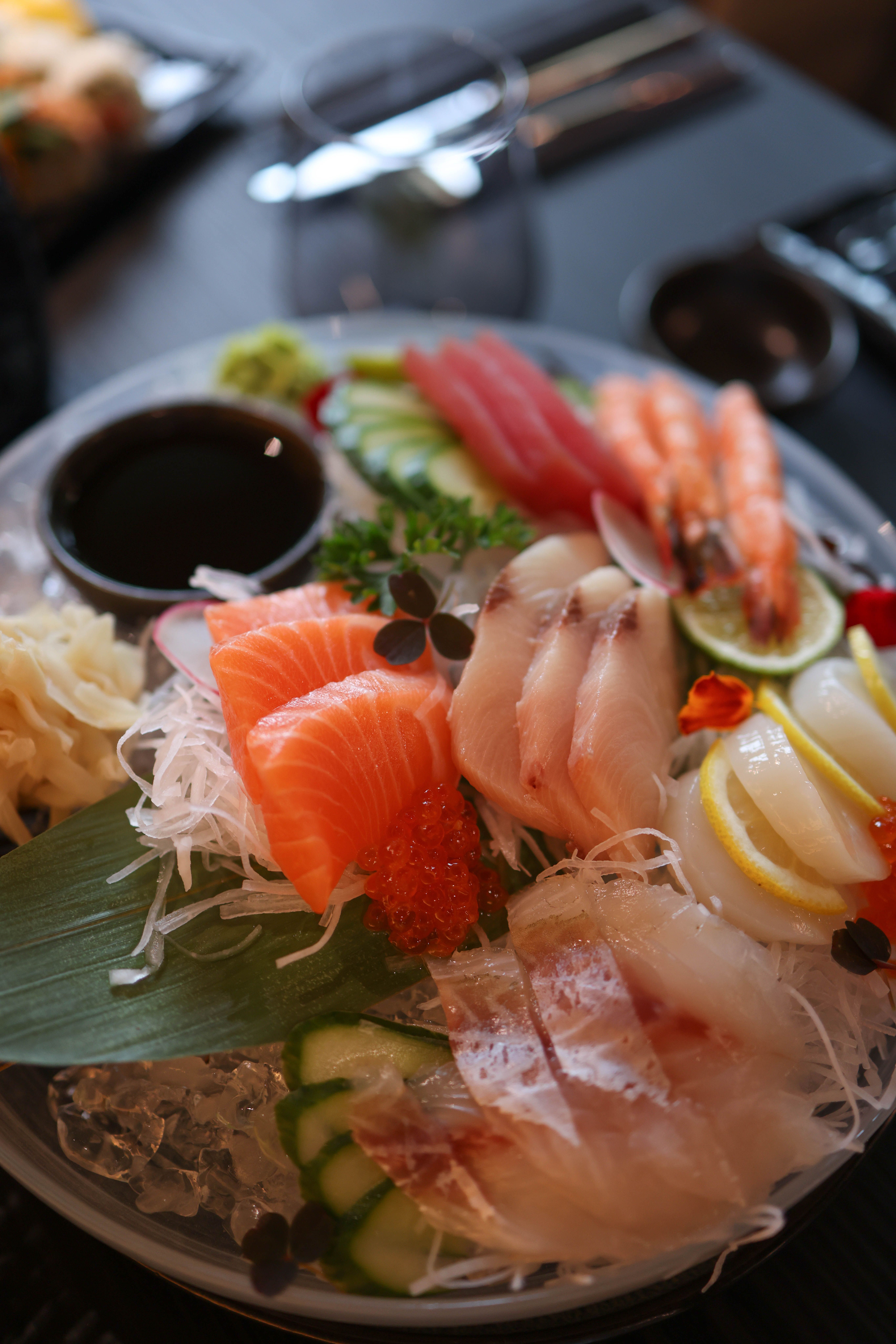 Chef-prepared sashimi plate with sliced raw fish