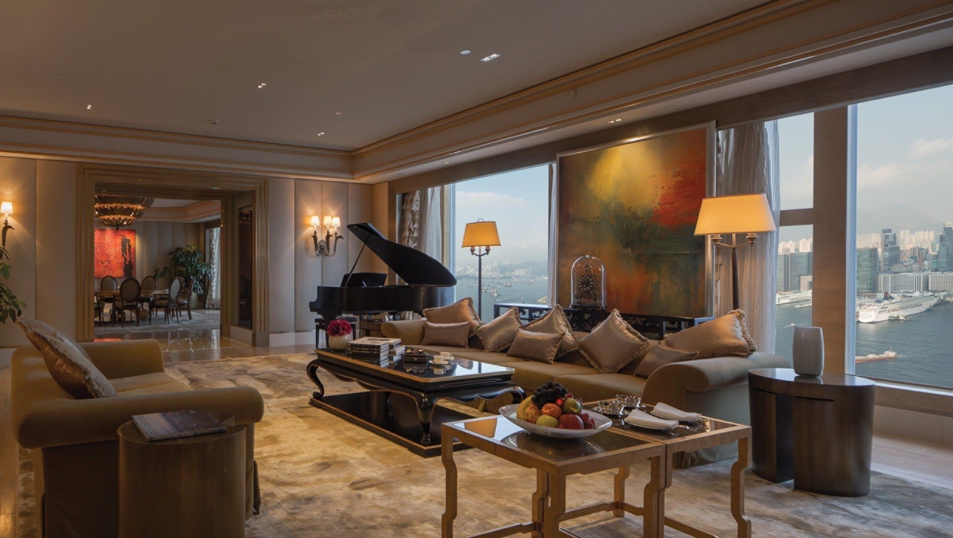 Grand piano and harbor-view seating area inside a luxury five-star hotel suite