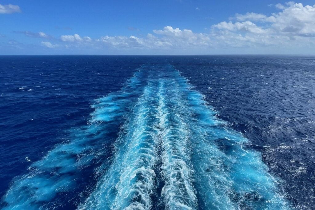 A cruise ship wake trailing across the open ocean