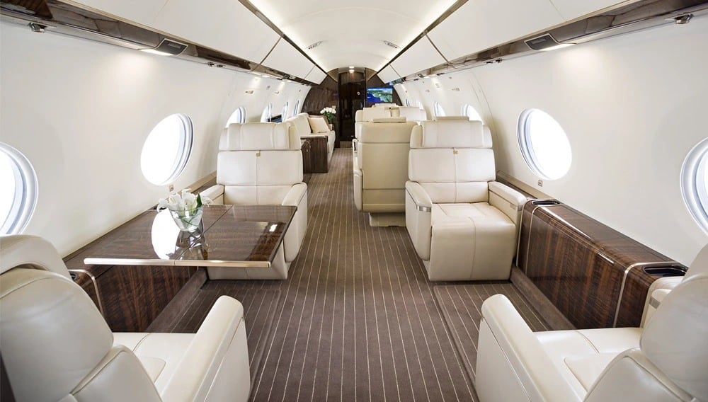 Luxury private jet cabin interior with cream leather seats
