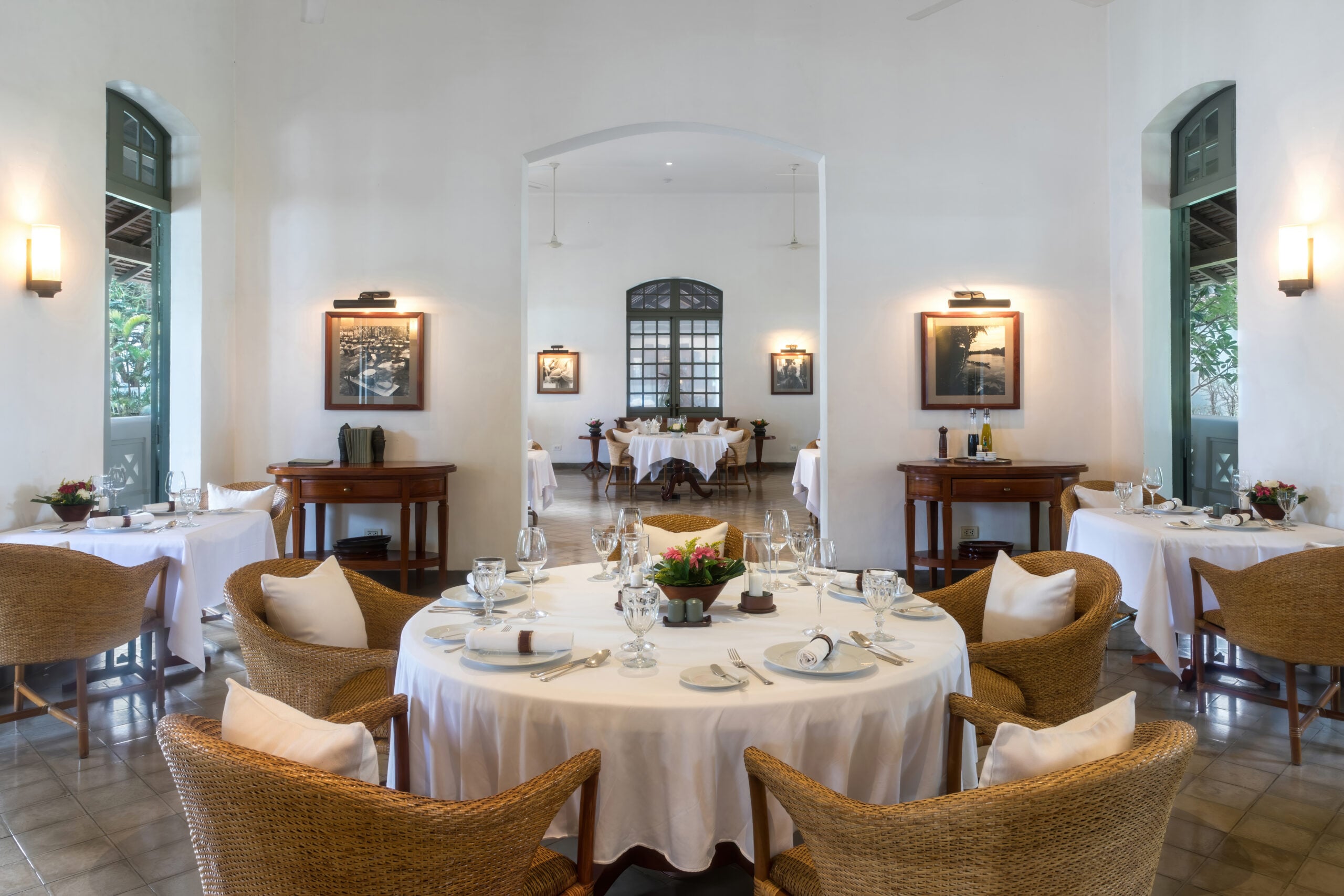 Elegant restaurant dining room with set tables at the Amantaka luxury resort in Laos