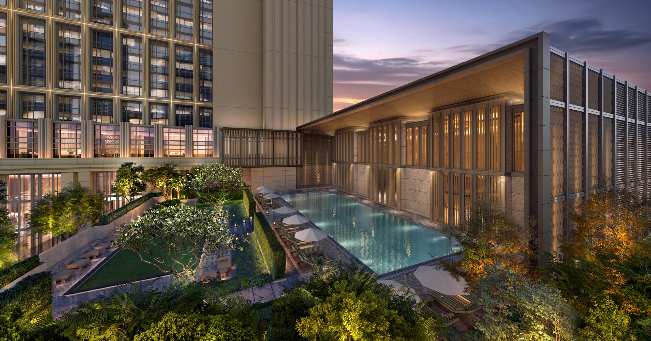 Rooftop swimming pool with lounge chairs at the Waldorf Astoria Kuala Lumpur at dusk